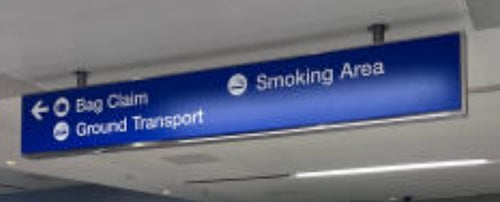 You'll find a blue sign hanging from the ceiling near the area where you can vape at LAX Airport.